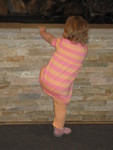 Madison trying to climb into a fountain (she calls it a tubby) at the mall