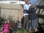 Grandma Smith and Justin helping Owen and Madison find eggs