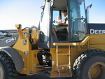 Jordan and Madison driving in the John Deer Backhoe