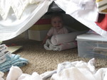 Madison crawled backwards - the only direction she could go - and ended up under the bed playing with wrapping paper and bows