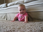 Madison crawling in the only direction she knows, wedged herself under the couch