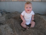 Madison sitting in freshly sifted dirt in our front yard