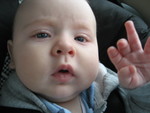 Paul waving good bye in his car seat