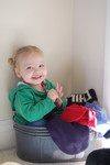 Madison playing in Grandma's hat basket 2