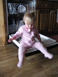 Helping do the dishes - Madison likes to sit on the door and swing her legs!