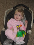 Madison sitting in her old carseat watching cartoons