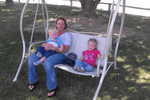 Grandma Newsome, Paul and madison on the swing at the Rockn' R Ranch