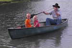 Grandpa Newsome and Madison and Ethan in the canoe at Rockn' R Ranch