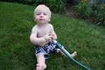 Paul playing with the hose at grandma smiths house