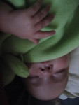 Cuddling with her frog blanket while napping