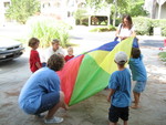 Cousins playing with the parachute