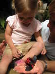 Madison and Grandma Newsome holding a butterfly in butterfly world in Oregon