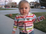 Madison putting leaves on her sweater - she likes to pretend they are stickers