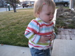 Putting leaves on her sweater - they look like stickers to her