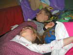 Madison and Paul sleeping in the fort Daddy built for them