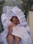 Keeping warm in a towel and baby swing after a shower