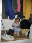 Madison playing in the coat closet