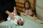 Cousins Lauren and Melanie admiring baby Madi